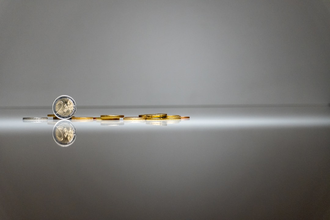 a-silver-and-gold-object-with-a-reflection-in-the-water-1dh7irtvwwa